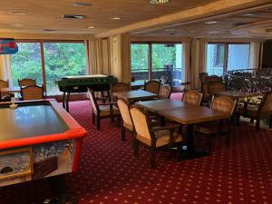 a dining room with tables and a pool table at Kronenlodge in Seefeld in Tirol