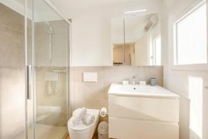 a bathroom with a toilet and a sink and a shower at Casa Elvezia in Val Colla | Terrace + BBQ & Fireplace - Happy Rentals in Piandera