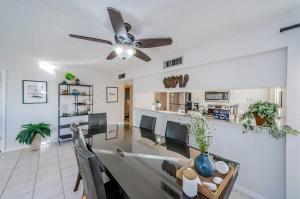 a living room with a dining table and a ceiling fan at Hidden Beach Retreat in Clearwater Beach