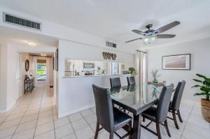 a dining room and kitchen with a table and chairs at Hidden Beach Retreat in Clearwater Beach
