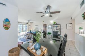 a living room with a table and a ceiling fan at Hidden Beach Retreat in Clearwater Beach