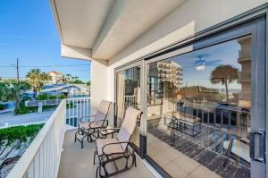 a balcony with chairs and a view of the ocean at Hidden Beach Retreat in Clearwater Beach