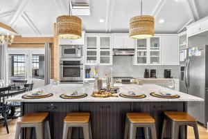 a kitchen with a large island with bar stools at Gulf Front Dreams in Clearwater Beach