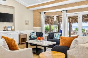 a living room with two couches and a table at Gulf Front Dreams in Clearwater Beach +57 photos