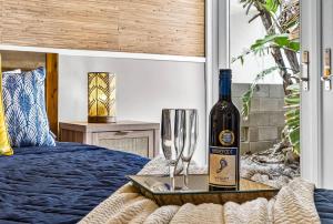 a bottle of wine on a tray with a wine glass at Gulf Front Dreams in Clearwater Beach