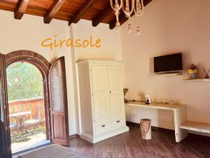 a room with a white cabinet and a tv on a wall at B&B Bernacco in Vallio Terme
