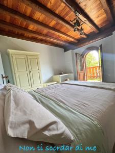a bedroom with a large bed with a wooden ceiling at B&B Bernacco in Vallio Terme