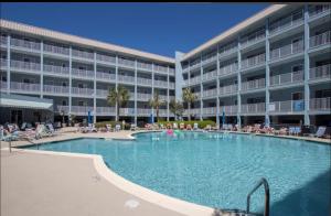 a large swimming pool in front of a hotel at Hilton Head Resort in Hilton Head Island