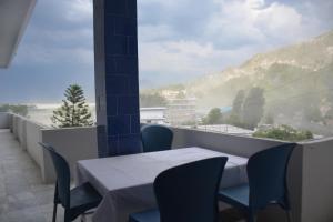 a table and chairs on a balcony with a view at Hotel Hills City, Swat in Mingāora