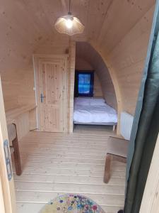 a small room with a bed and a window at Houx POD in Saint-Racho +5 photos