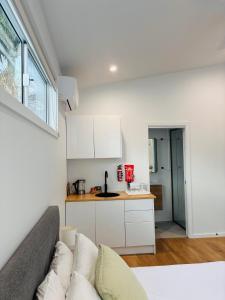 a living room with a couch and a kitchen at Sapphire Beach Studio in Sapphire Beach