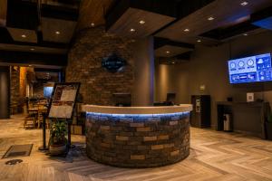 a bar in a restaurant with a brick wall at Hotel Punto MX in Mexico City