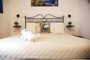 a bedroom with a white bed with towels on it at La Stellina Capri in Capri