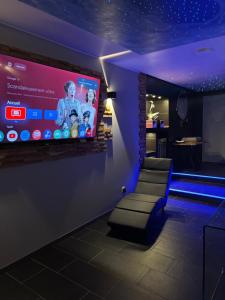 a room with a large screen on a wall at Work In Spa in Voiron