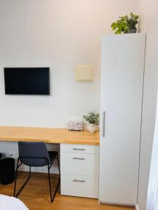 a room with a desk with a large white refrigerator at Sapphire Beach Studio in Sapphire Beach +5 photos
