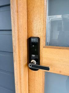 a black unlocking a door with a window at Sapphire Beach Studio in Sapphire Beach
