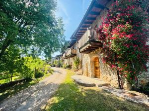 a stone house with flowers on the side of it at B&B Bernacco in Vallio Terme