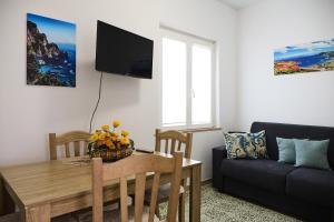 a living room with a table and a couch at La Stellina Capri in Capri