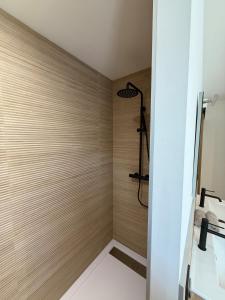 a bathroom with a shower with wooden walls at L'Annexe de la Subérine in Vivès +18 photos