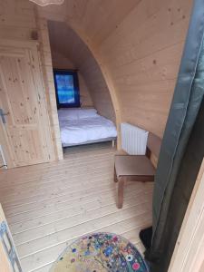 a small room with a bed and a chair at Houx POD in Saint-Racho