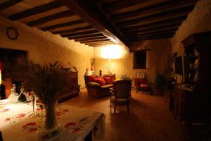 a living room with a couch and a table at Maison d'Hôtes Les Après in Bellême