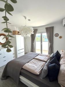 a bedroom with a large bed and a chandelier at Villa Noma in Lovište