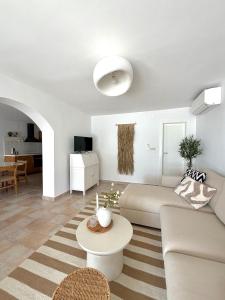 a white living room with a couch and a table at Villa Noma in Lovište