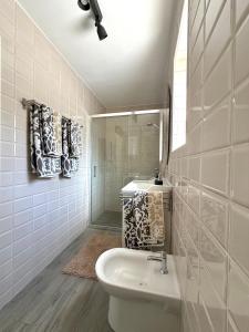 a white bathroom with a sink and a mirror at Villa Noma in Lovište +39 photos