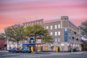 a building on a street with cars parked in front at Best Western Gregory Hotel in Brooklyn