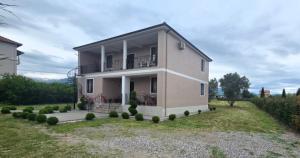 a house with a balcony and a yard at Your Home Away from Home in Shkodër