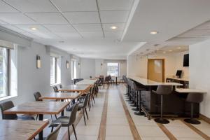 a row of tables and chairs in a restaurant at Best Western Gregory Hotel in Brooklyn