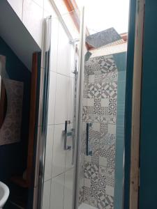 a shower with a glass door in a bathroom at Soleil Bleu in Saint-Racho