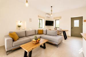 a living room with a couch and a table at Villa Castillo Thio in Agios Nikolaos