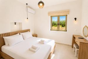 a bedroom with a bed and a desk and a window at Villa Castillo Thio in Agios Nikolaos +9 photos