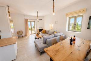 a living room with a table and a couch at Villa Castillo Thio in Agios Nikolaos