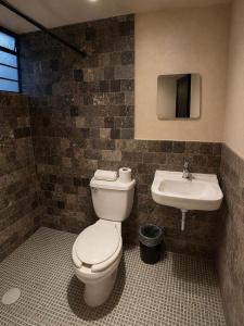 a bathroom with a toilet and a sink at Hotel Mary o in Valle de Bravo
