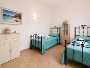a bedroom with two beds and a dresser and the ocean at Two Bedroom With Pool Taty Apartment in Porto Cervo +8 photos
