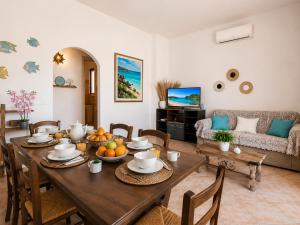 a living room with a table and a couch at Two Bedroom With Pool Taty Apartment in Porto Cervo