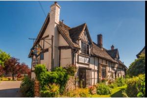 an old house in the middle of a street at Spring Cottage Bretforton in Bretforton