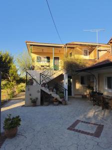 a house with a patio in front of it at Fimi's apartment in Fiolítis