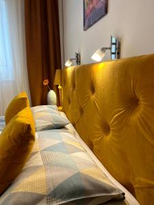 a yellow bed with two pillows on top of it at Apartment Natasa in Rab +29 photos