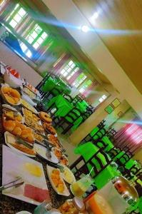 a buffet line with many plates of food at Hotel Jardim Tropical in Barcarena