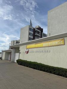 a building with a sign on the side of it at Nene Homes in Marimbeti