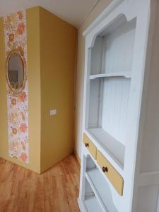 a room with a closet with a shelf and a mirror at Passiflore in Saint-Racho