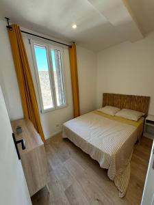a bedroom with two beds and a window at Appartements Agde Cap d Agde in Agde