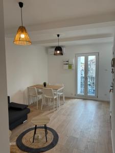 a living room with a table and chairs and a couch at Appartements Agde Cap d Agde in Agde
