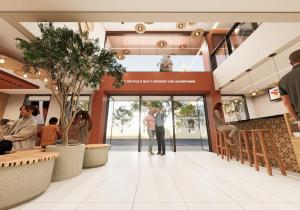 a lobby of a building with people walking into the door at Hotel JB in Juazeiro do Norte