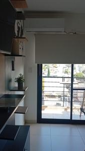 a kitchen with a large glass door to a patio at Apart del Centro 03 cochera opcional in Santa Fe