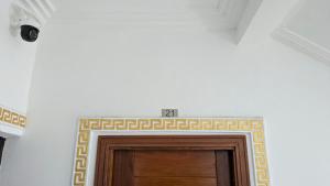 a door in a room with a tile border over it at Eva Apparts "situé à Kotto Baden Baden" - PARKING CAMERA BALCON WIFI CLIM CONFORT in Douala