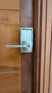 a door with a lock on a wooden door at Eva Apparts "situé à Kotto Baden Baden" - PARKING CAMERA BALCON WIFI CLIM CONFORT in Douala +13 photos